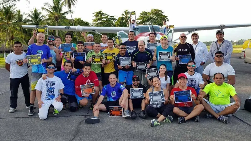 A large group of students holding their canopy course certificates