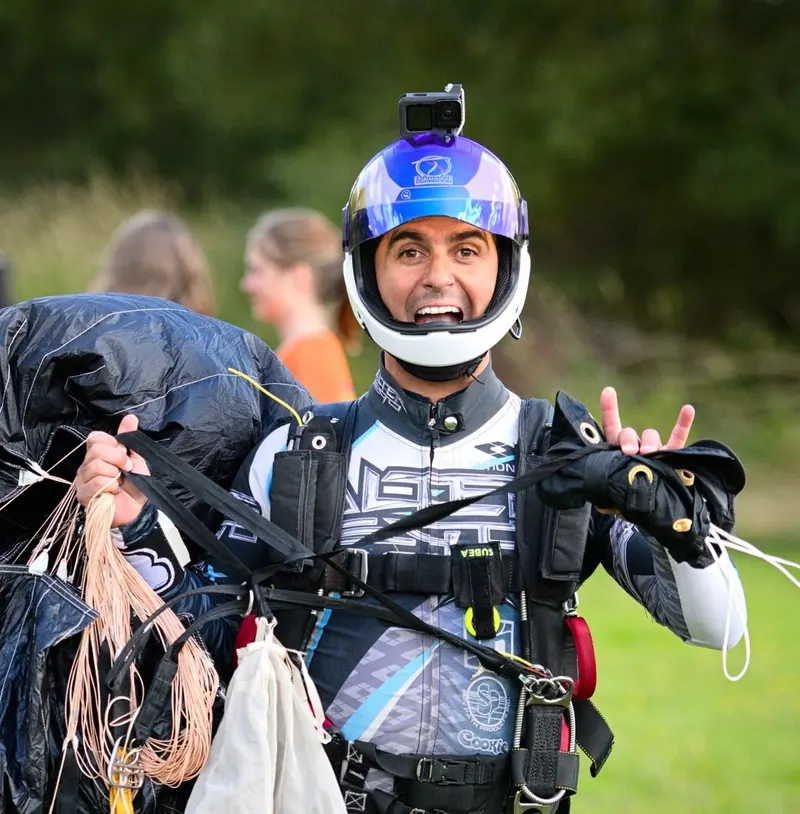 Marcos Darman smiling in his helmet after a jump
