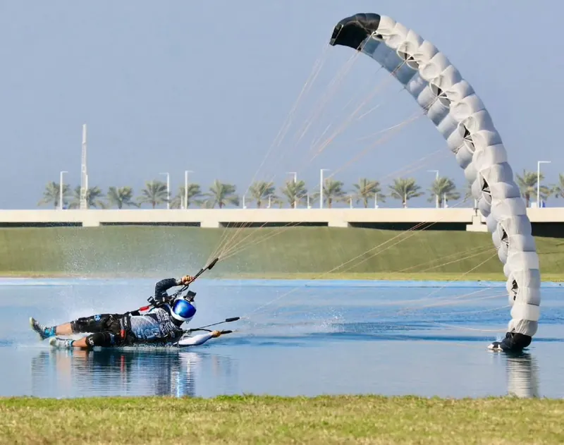 Marcos Darman dragging a hand across the pond during a freestyle swoop