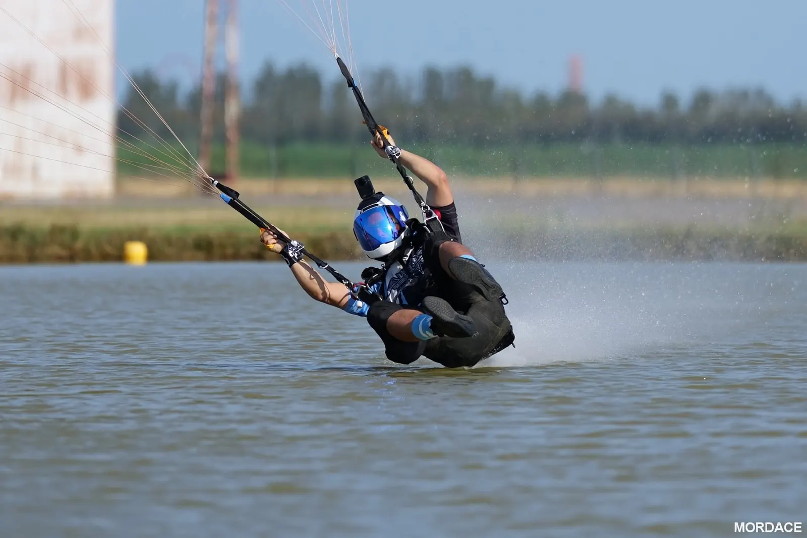 Marcos Darman dragging his feet across the water during a high-performance landing