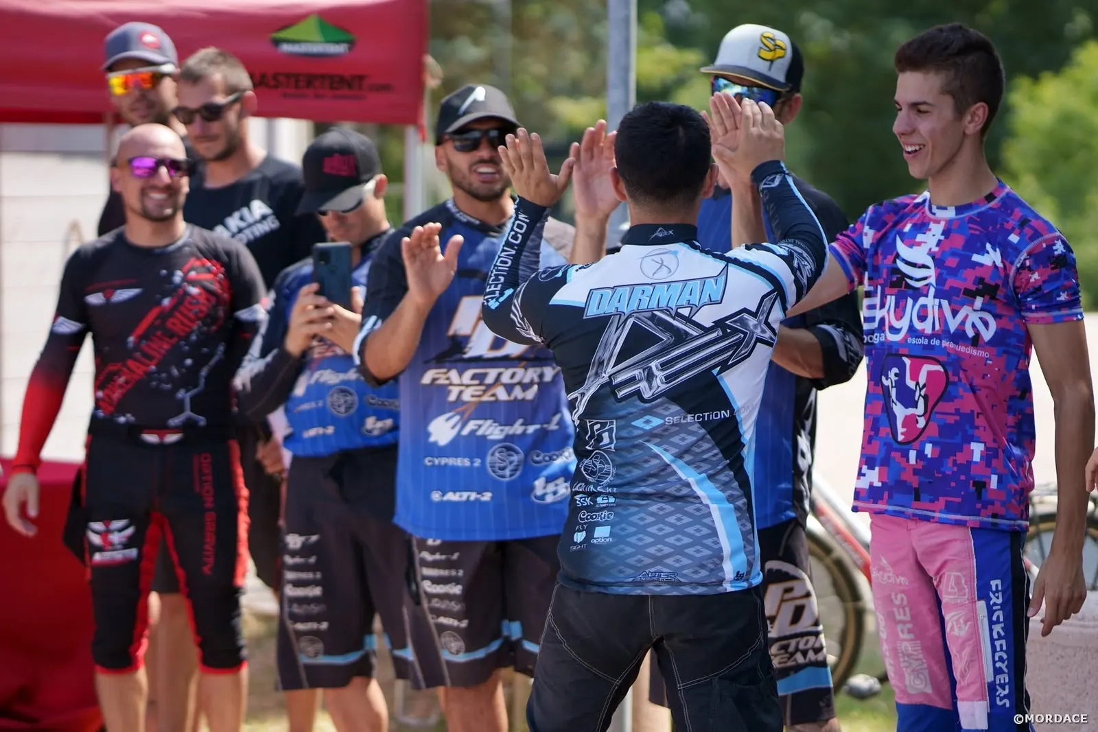 Marcos Darman high-fiving pilots at a canopy piloting event